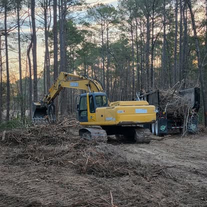 Work crew and machinery preparing ground at a development site.